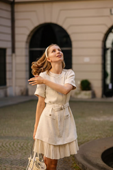 a lady wears a white wool blend tweed mini dress